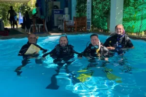 PADI Course Director and 3 instructor candidates pose during a pool training session